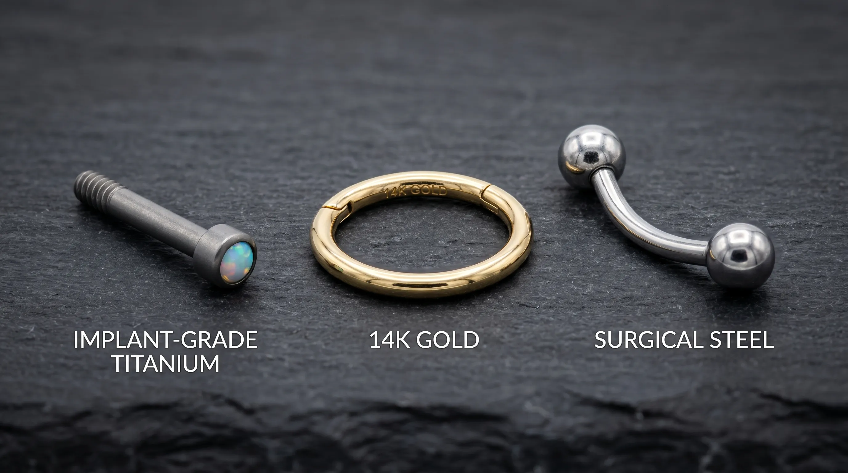 Close-up comparison of different body piercing jewelry materials on a dark slate background, including implant-grade titanium, 14k gold, and surgical steel, high detail, product photography style