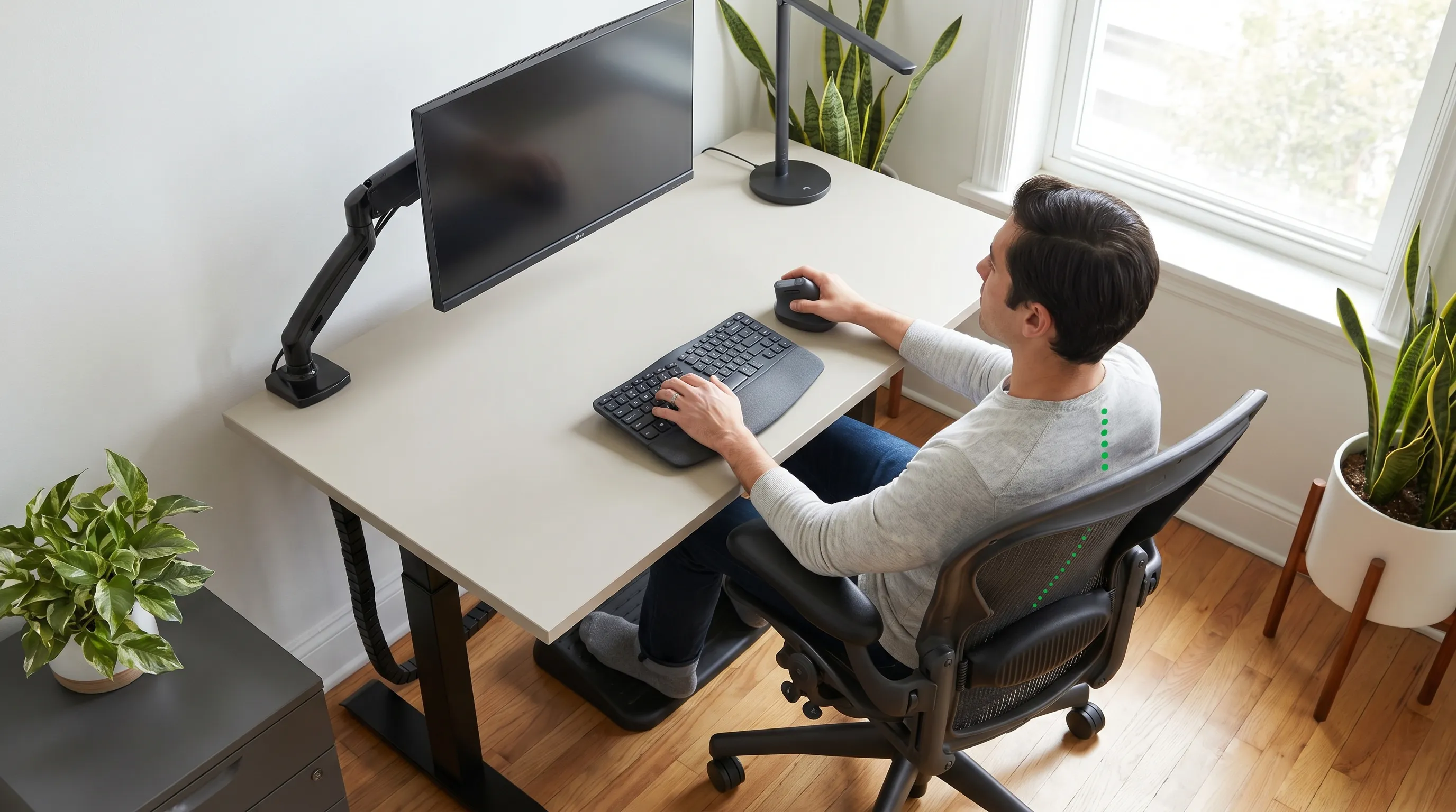 An ergonomic office setup with proper lumbar support, monitor alignment, and neutral spine posture
