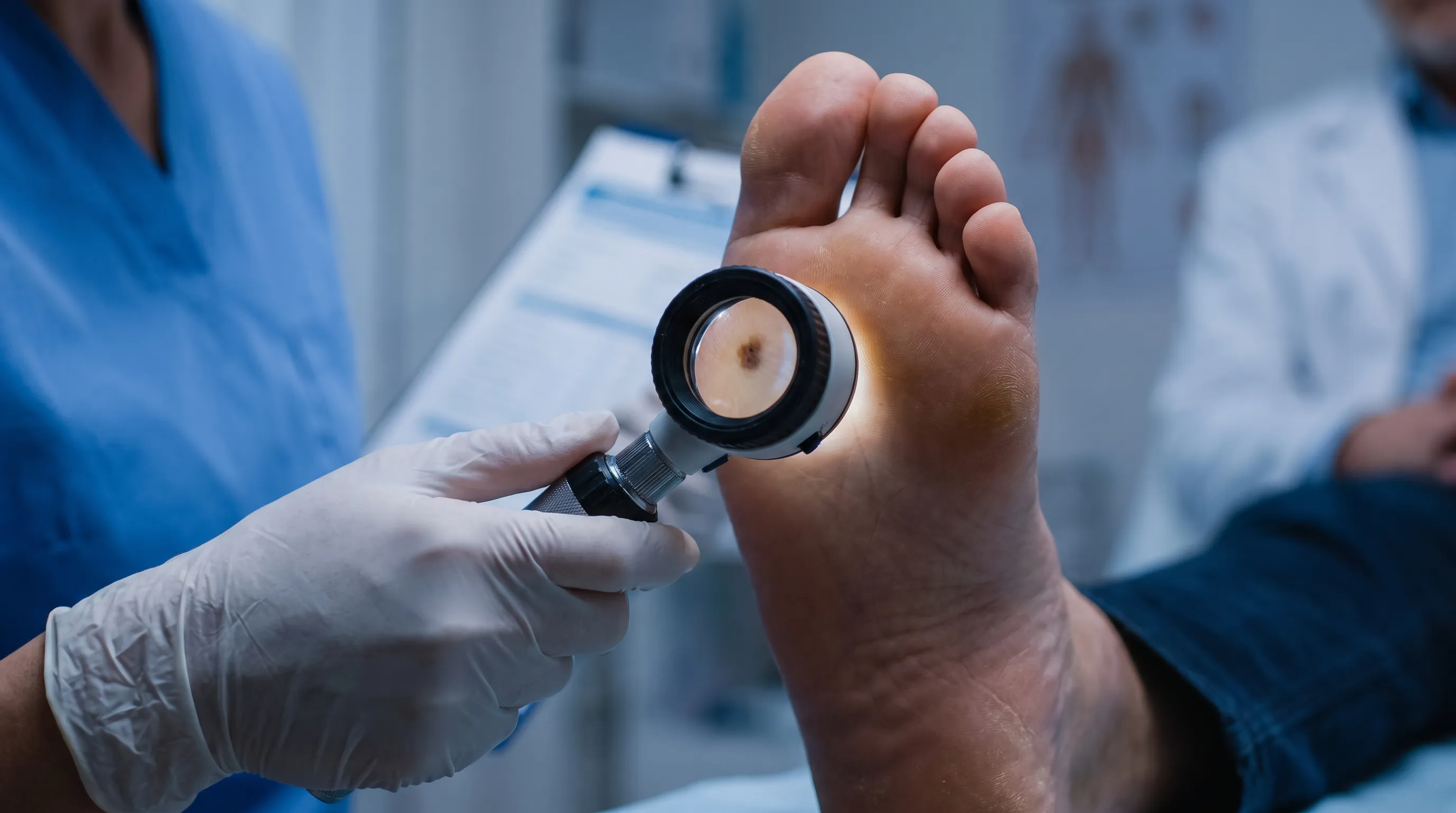 Close-up clinical image of a podiatrist examining plantar skin texture and pigmentation under bright examination lighting, emphasizing careful diagnostic procedure