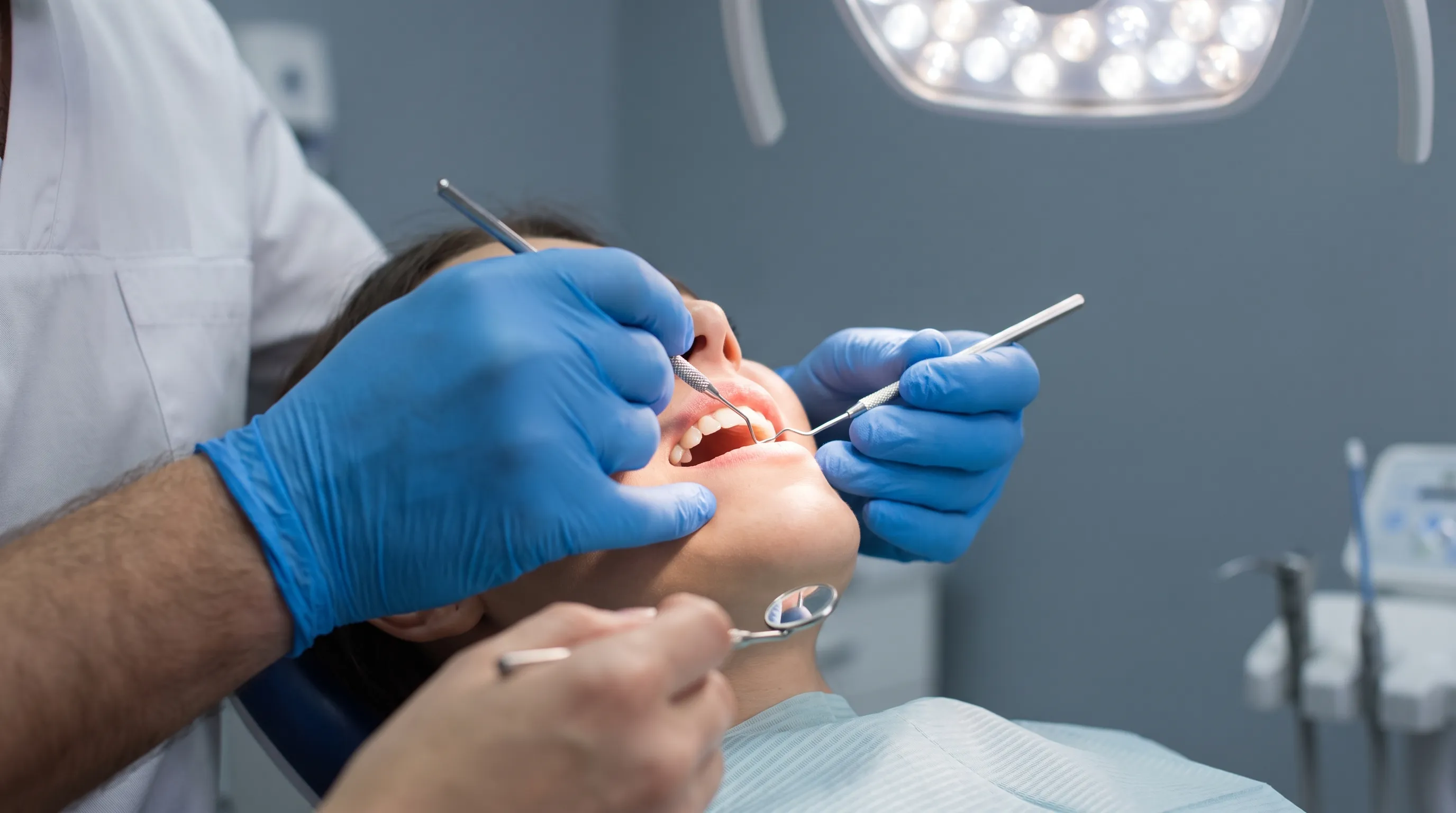 Patient undergoing professional dental examination for tooth discoloration assessment