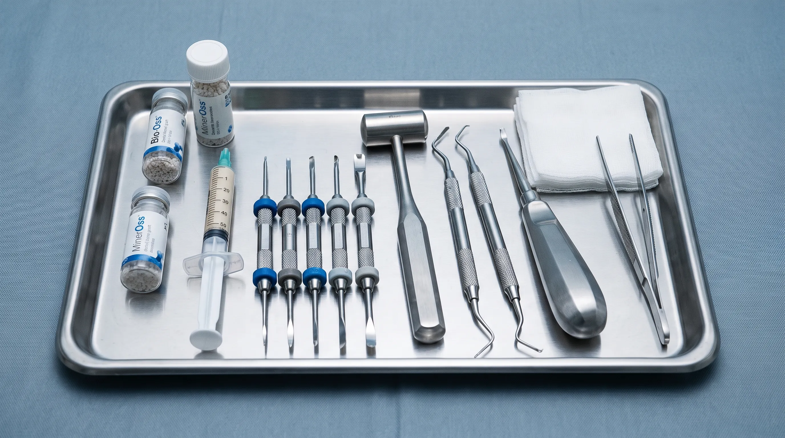 Close-up of a sterile surgical tray showing dental bone graft materials, surgical instruments, and a sinus lift instrument set, clean blue-gray background, professional medical photography, 4:3 ratio