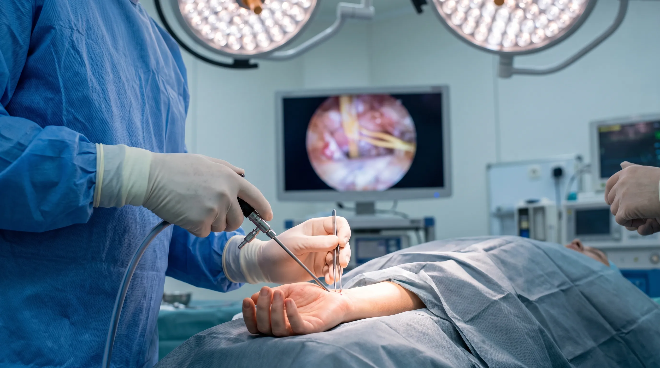 Surgeon performing minimally invasive endoscopic carpal tunnel release in a sterile operating room